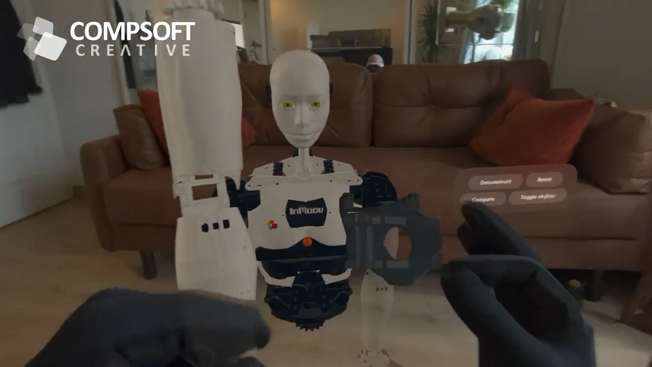 Black haptic gloves manipulating parts of a virtual robot in STAGEit on Apple Vision Pro