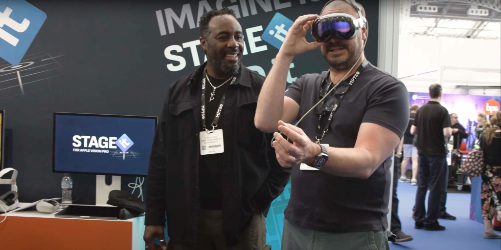 Trade show booth with STAGEit for Apple Vision Pro — two people, one wearing Apple Vision Pro